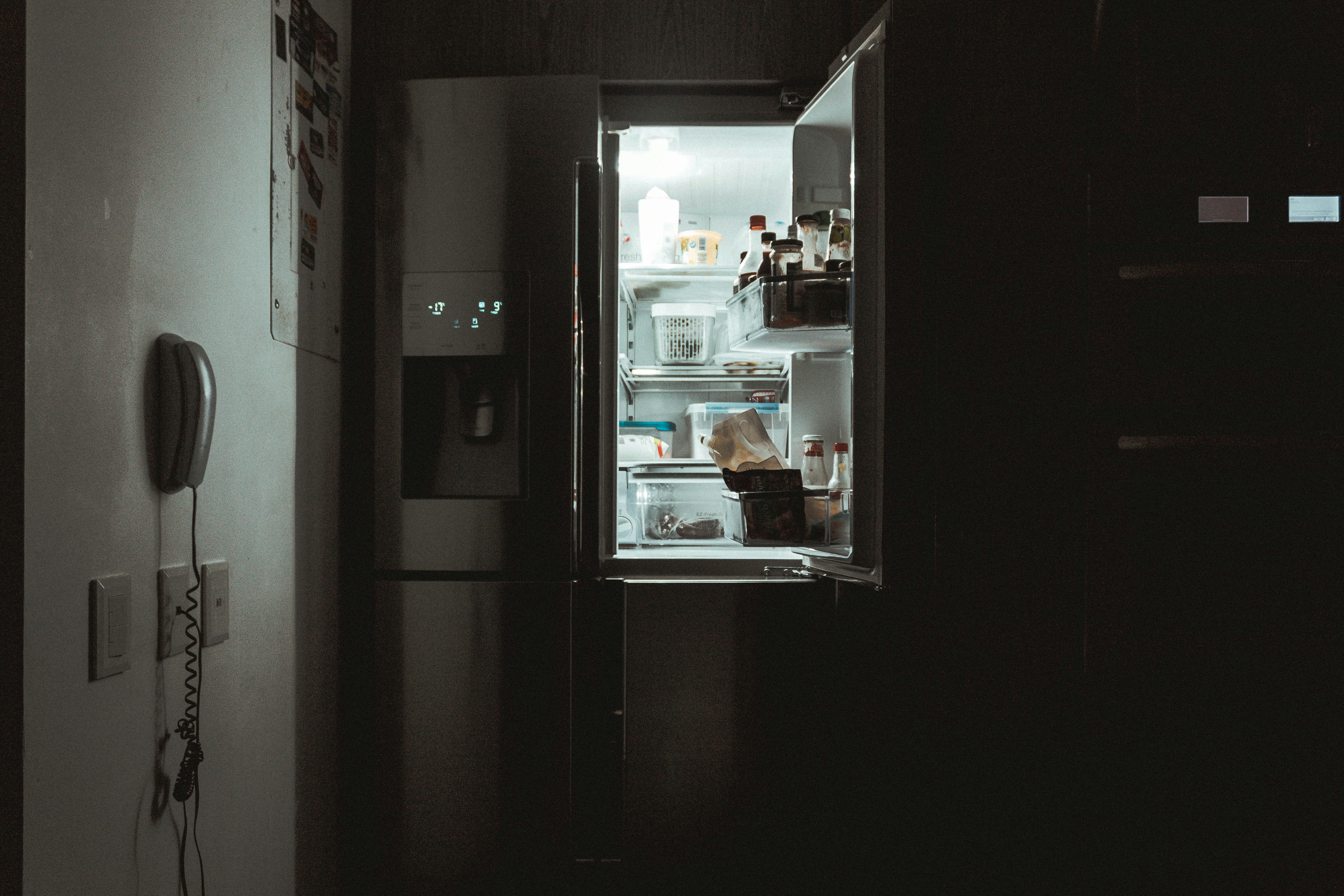 Image of a fridge with the door open showing food inside